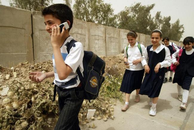 School boy using a cell phone