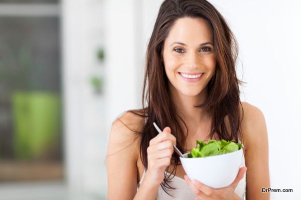 young woman eating healthy salad